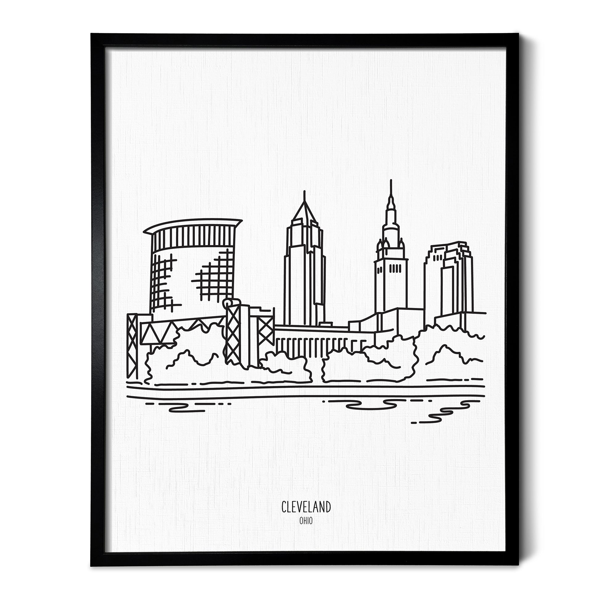 A line art drawing of the Cleveland Ohio Skyline on white linen paper in a thin black picture frame