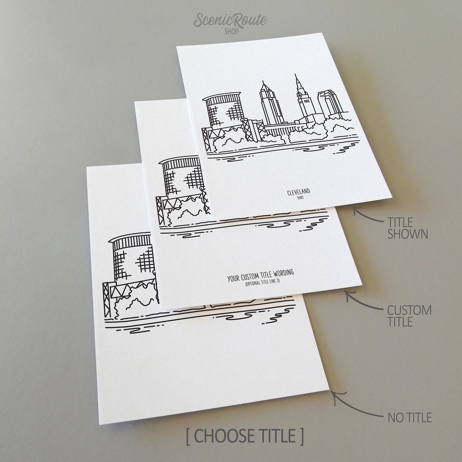 Three line art drawings of the Cleveland Ohio Skyline on white linen paper with a gray background. The pieces are shown with title options that can be chosen and personalized.