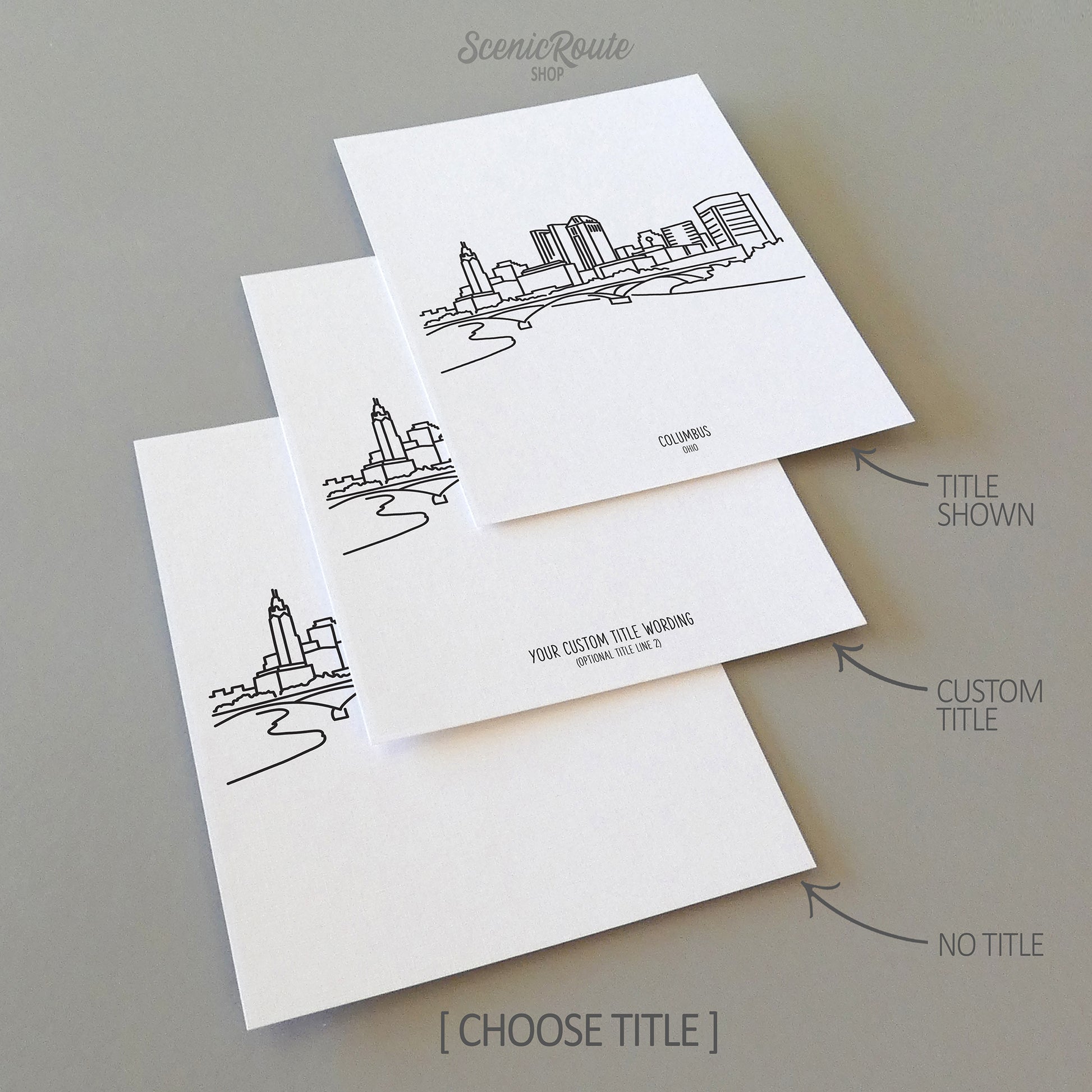 Three line art drawings of the Columbus Ohio Skyline on white linen paper with a gray background. The pieces are shown with title options that can be chosen and personalized.