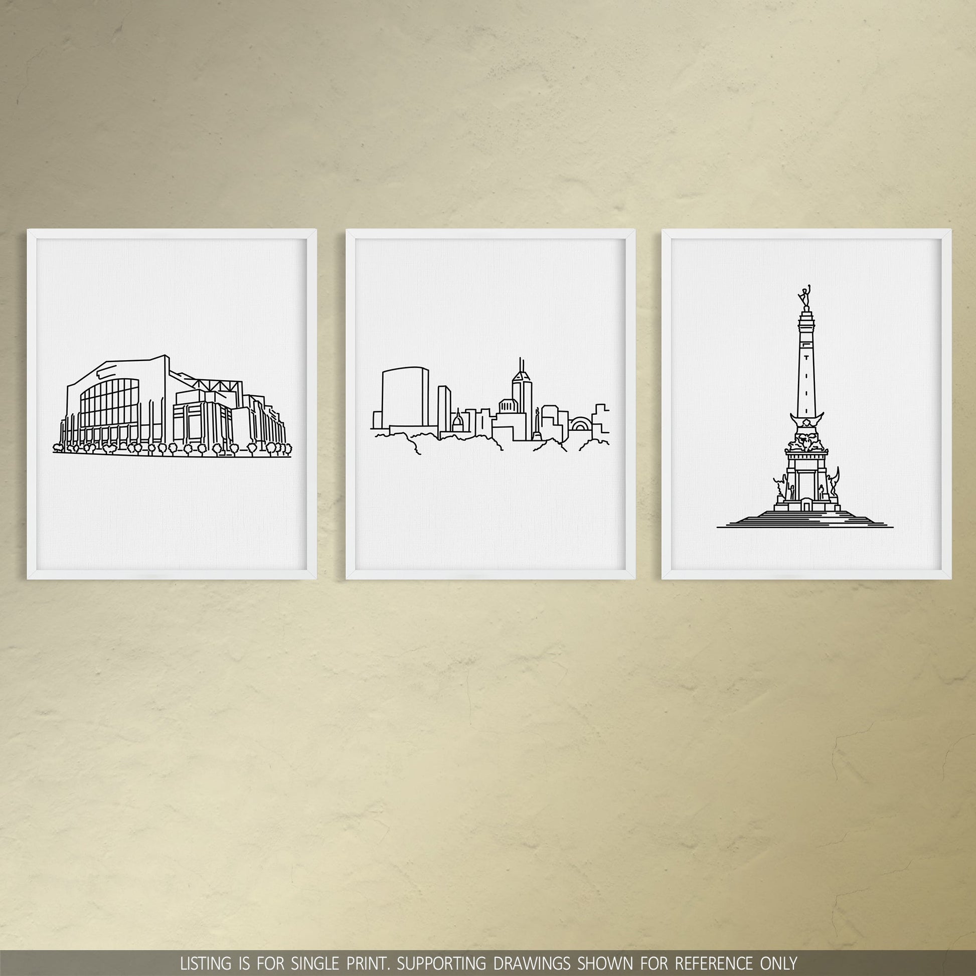 A group of three framed drawings on a wall. The line art drawings include the Colts Stadium, Indianapolis Skyline, and Soldiers and Sailors Monument