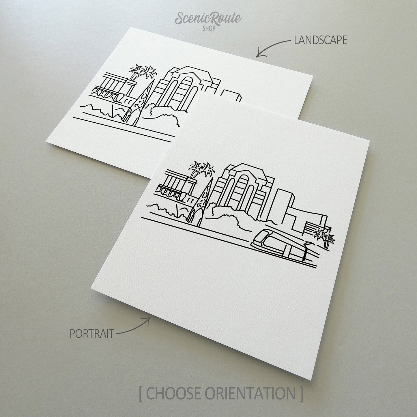 Two line art drawings of the Mesa Skyline on white linen paper with a gray background. The pieces are shown in portrait and landscape orientation for the available art print options.