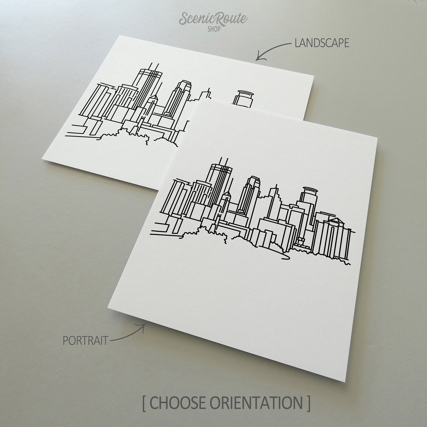 Two line art drawings of the Minneapolis Skyline on white linen paper with a gray background. The pieces are shown in portrait and landscape orientation for the available art print options.