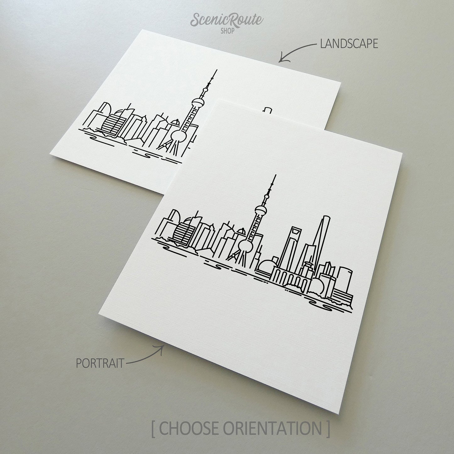 Two line art drawings of the Shanghai Skyline on white linen paper with a gray background. The pieces are shown in portrait and landscape orientation for the available art print options.