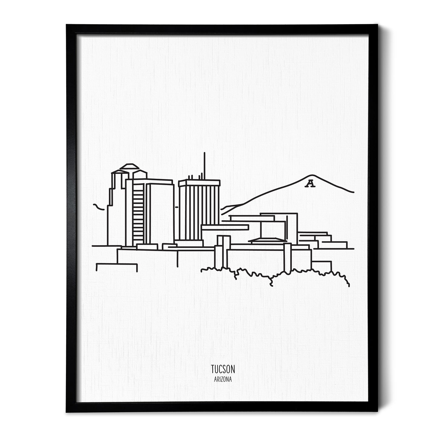 A line art drawing of the Tucson Arizona Skyline on white linen paper in a thin black picture frame