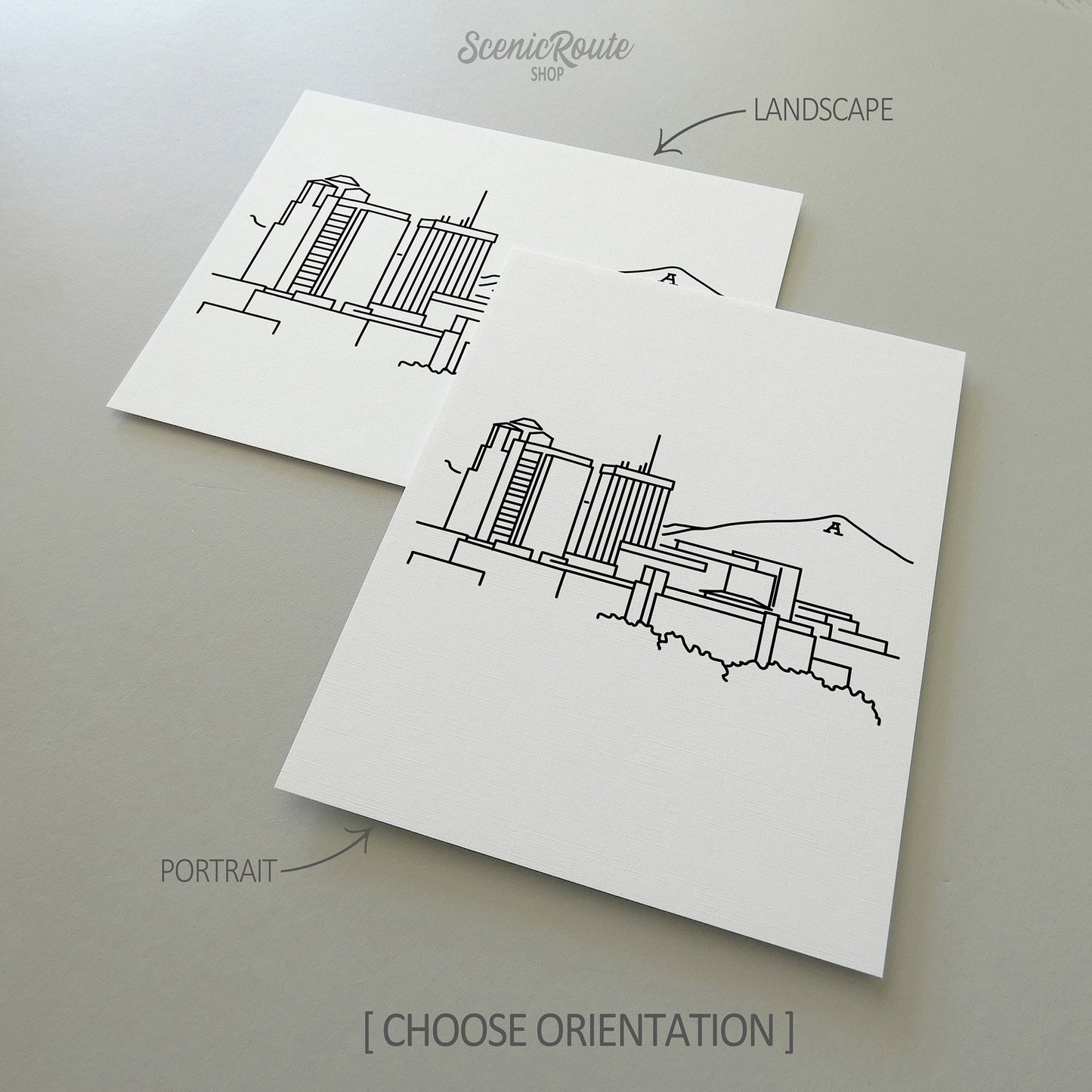 Two line art drawings of the Tucson Skyline on white linen paper with a gray background. The pieces are shown in portrait and landscape orientation for the available art print options.