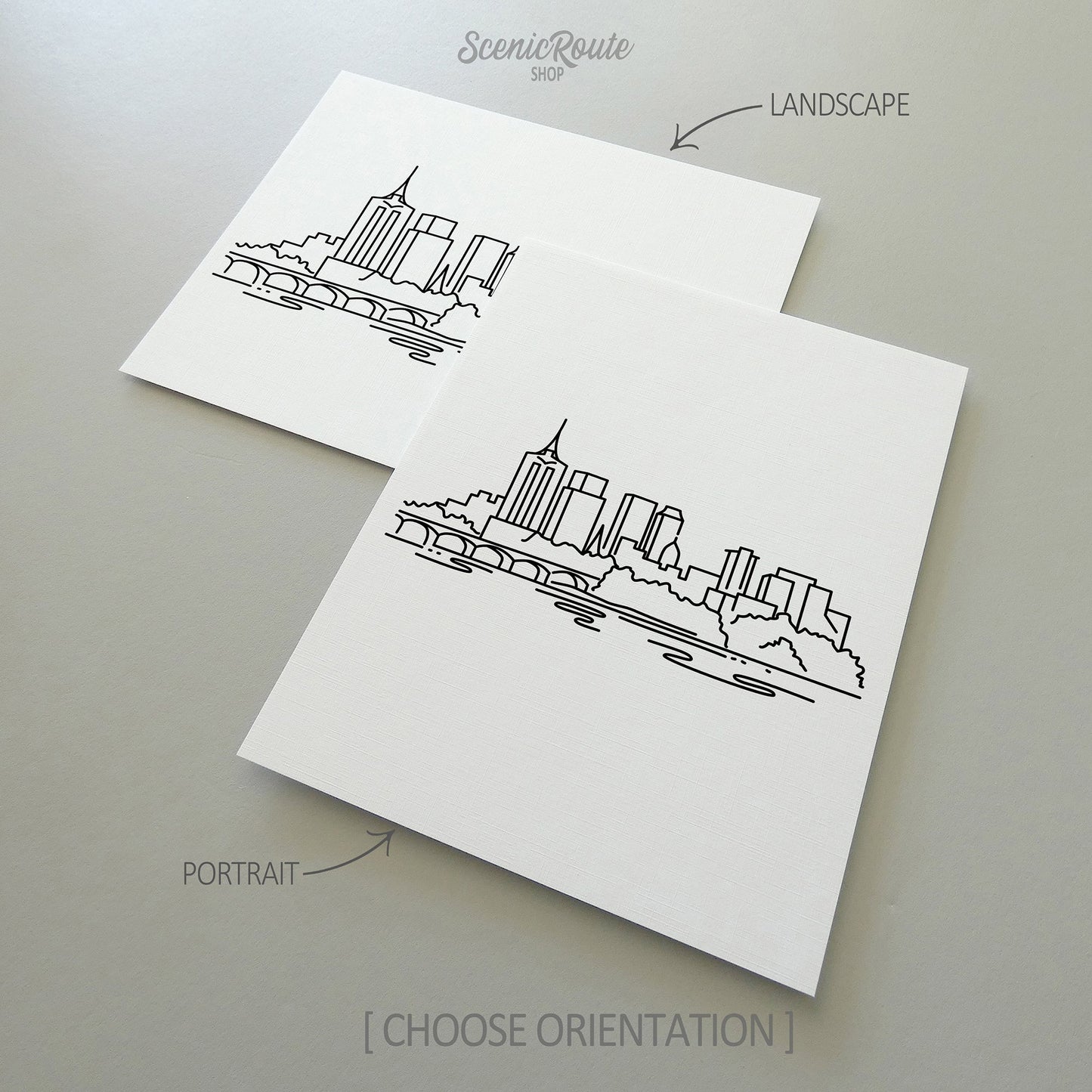 Two line art drawings of the Tulsa Skyline on white linen paper with a gray background. The pieces are shown in portrait and landscape orientation for the available art print options.