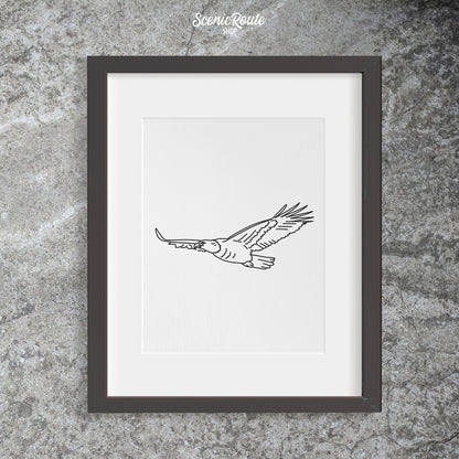 A framed line art drawing of an Eagle on a concrete wall