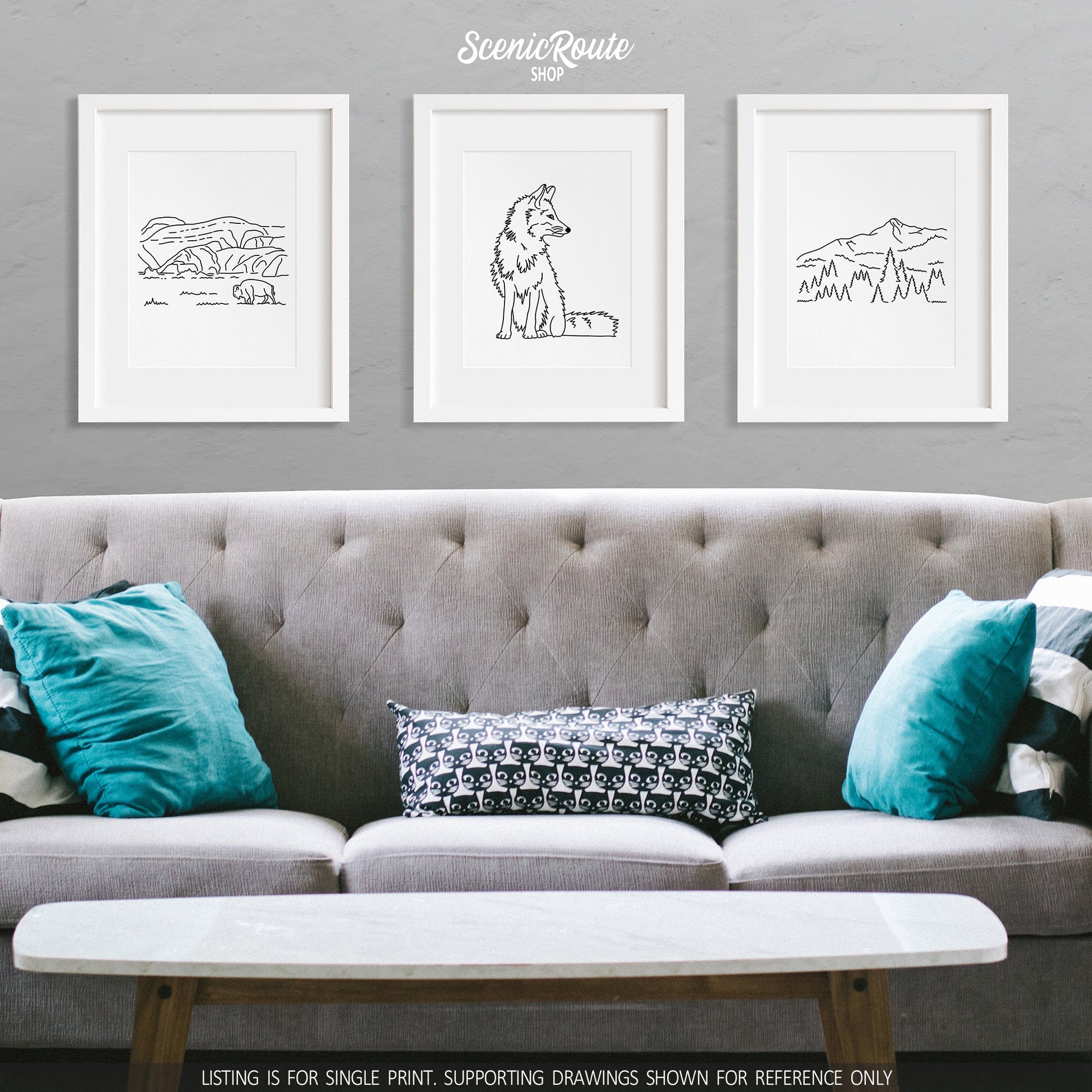 A group of three framed drawings on a wall above a couch. The line art drawings include Theodore Roosevelt National Park, a Fox, and Big Sky Montana