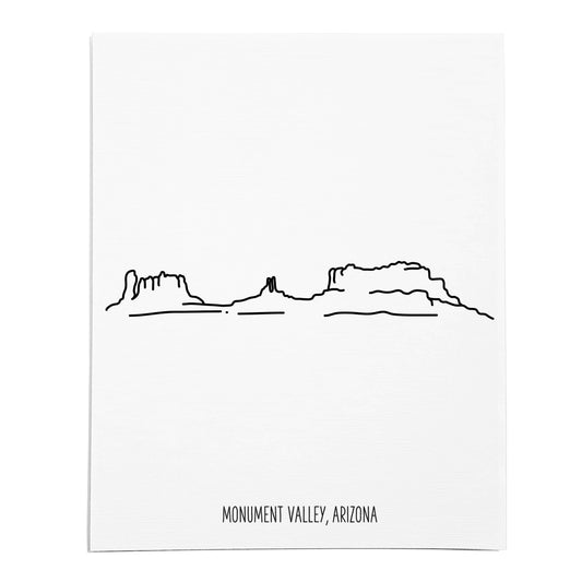 An art print featuring a line drawing of Monument Valley on white linen paper