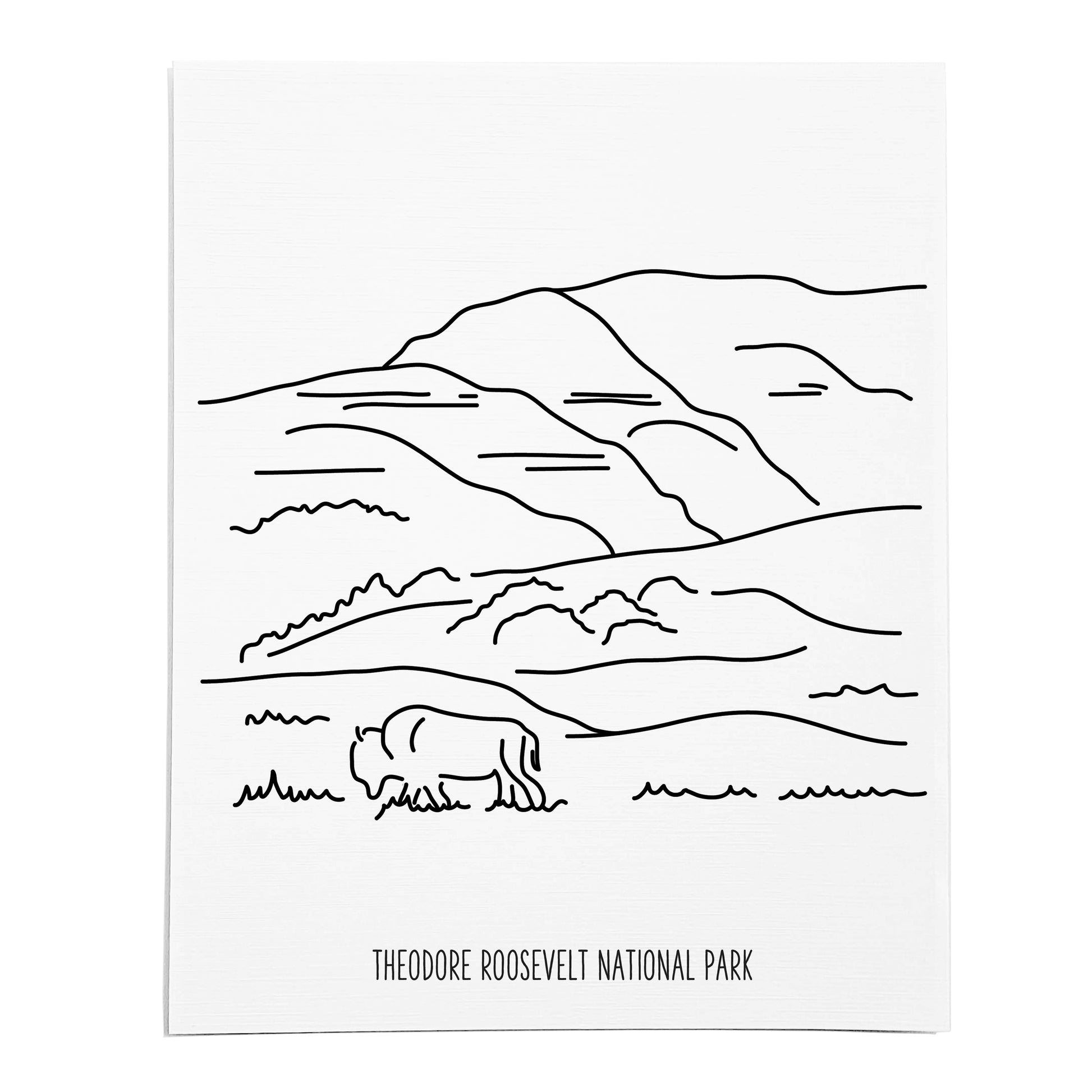 An art print featuring a line drawing of Theodore Roosevelt National Park on white linen paper