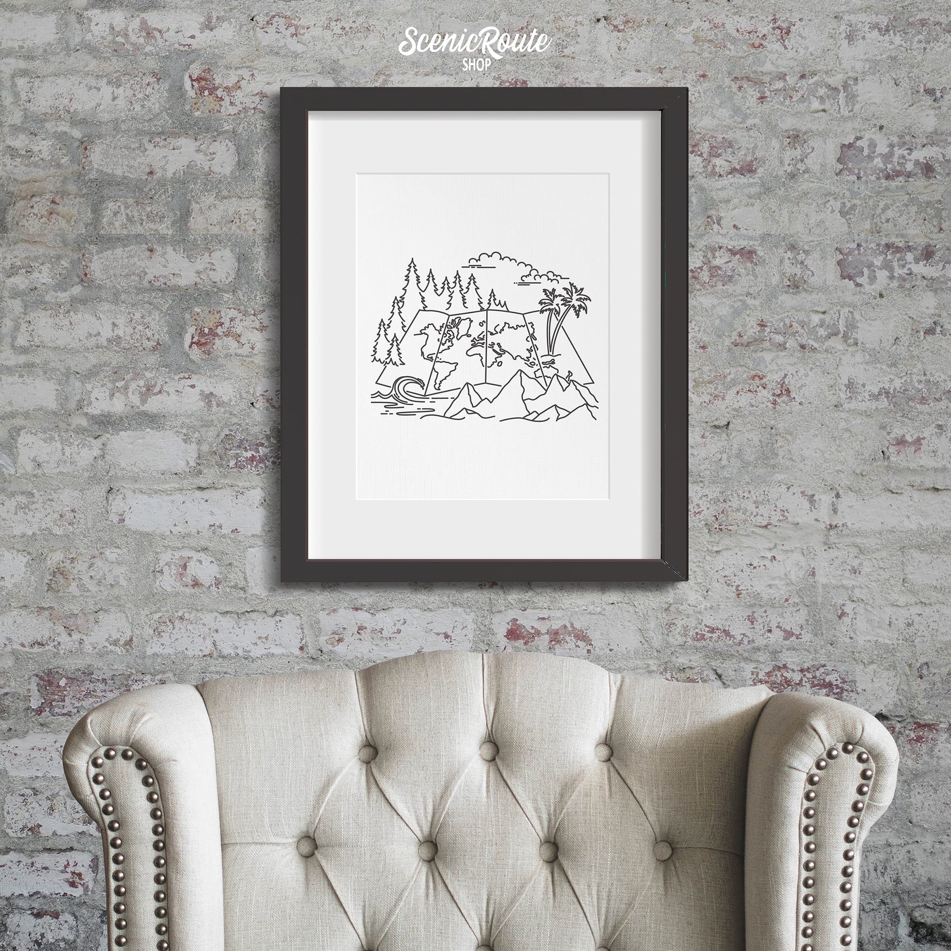 A framed line art drawing of the Adventure Map Drawing on a brick wall above a chair