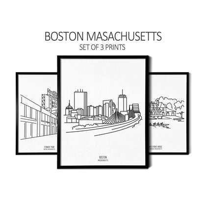 Line art drawings of the Boston Skyline, Fenway Park, and the Harvard Weld Boathouse on white linen paper in a thin black picture frames