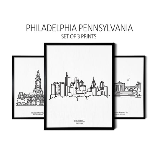 Custom line art drawings of the Philadelphia City Hall, Philadelphia Skyline, and Philadelphia Art Museum on white linen paper in thin black picture frames