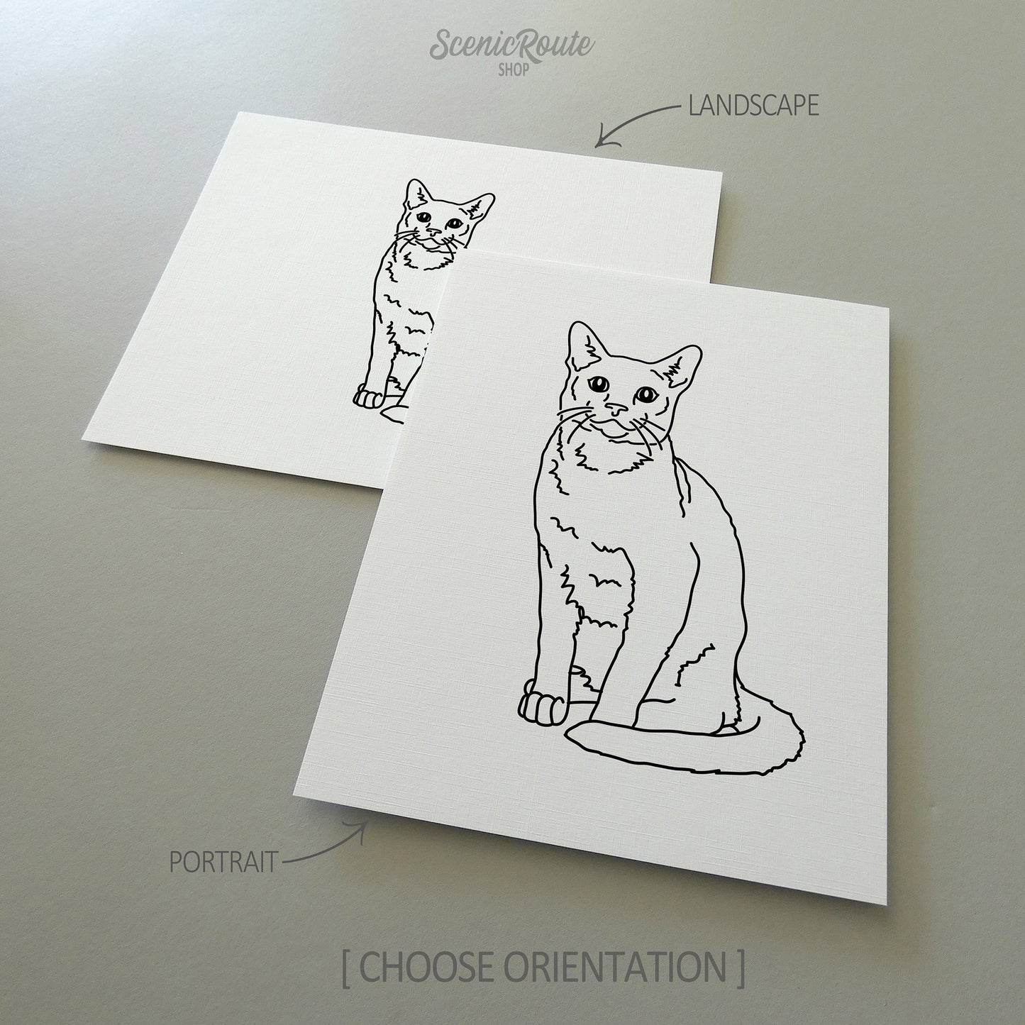 Two line art drawings of a Russian Blue cat on white linen paper with a gray background.  The pieces are shown in portrait and landscape orientation for the available art print options.
