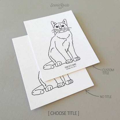 Two line art drawings of a Snowshoe Cat on white linen paper with a gray background.  The pieces are shown with “No Title” and “Custom Title” options for the available art print options.