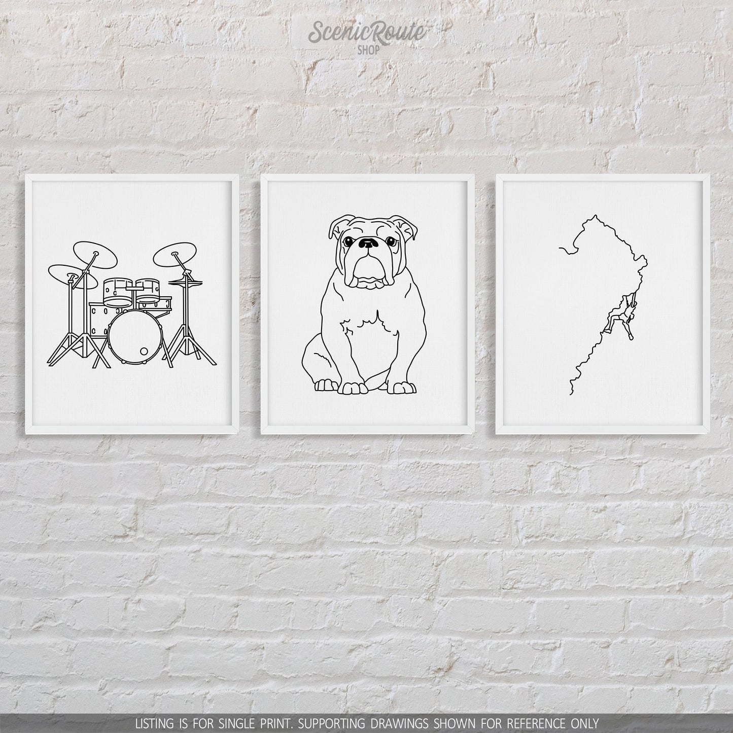 A group of three framed drawings on a brick wall.  The line art drawings include a set of Drums, a Bulldog, and a person Rock Climbing