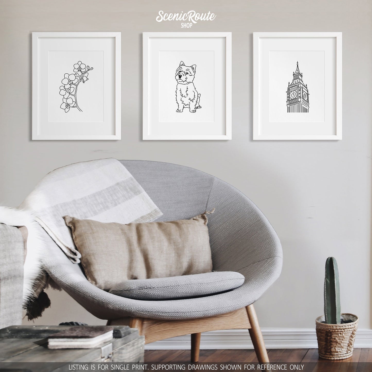 A group of three framed drawings on a white wall above a round chair. The line art drawings include an Orchid Flower, a Norwich Terrier dog, and Big Ben