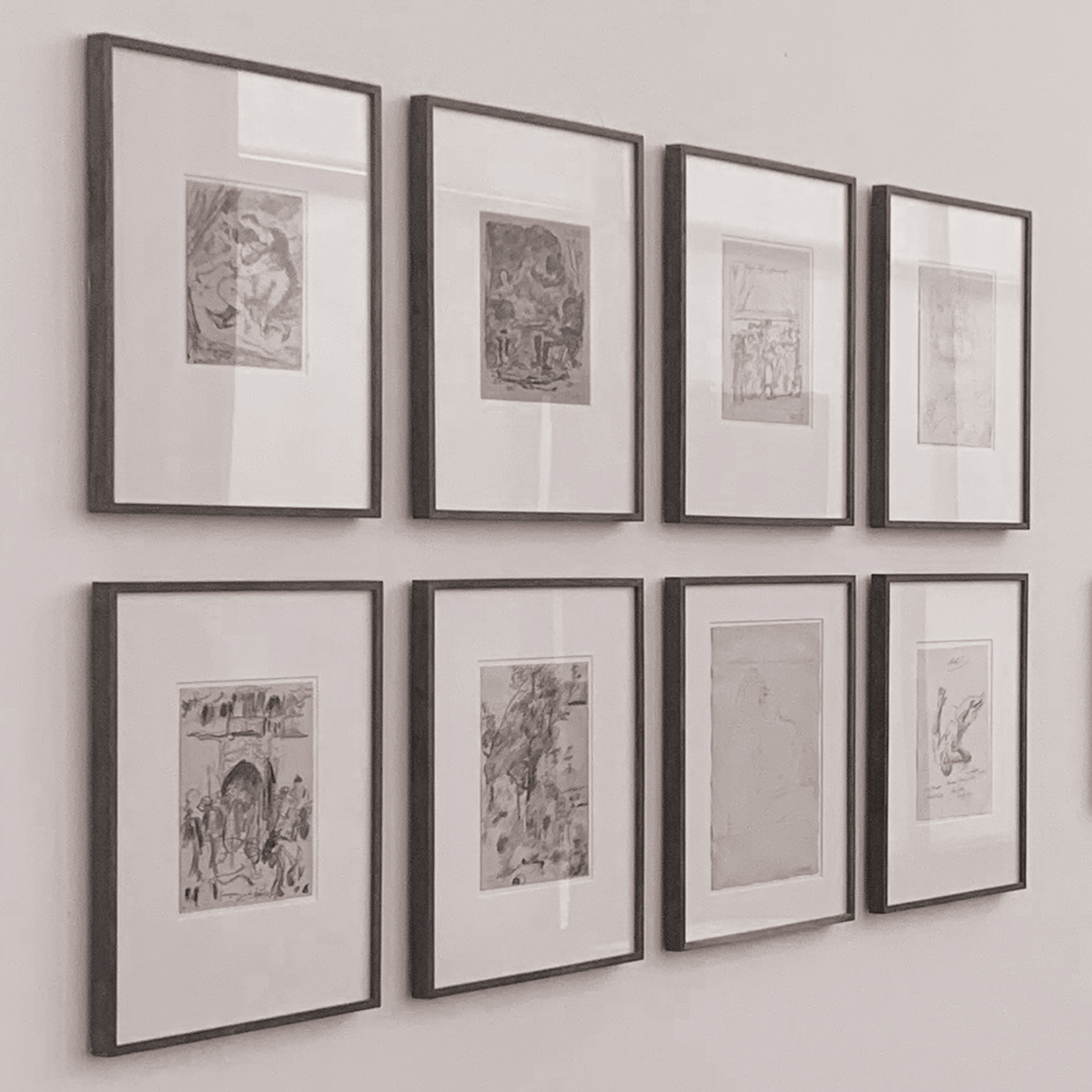 a gallery wall with eight square frames