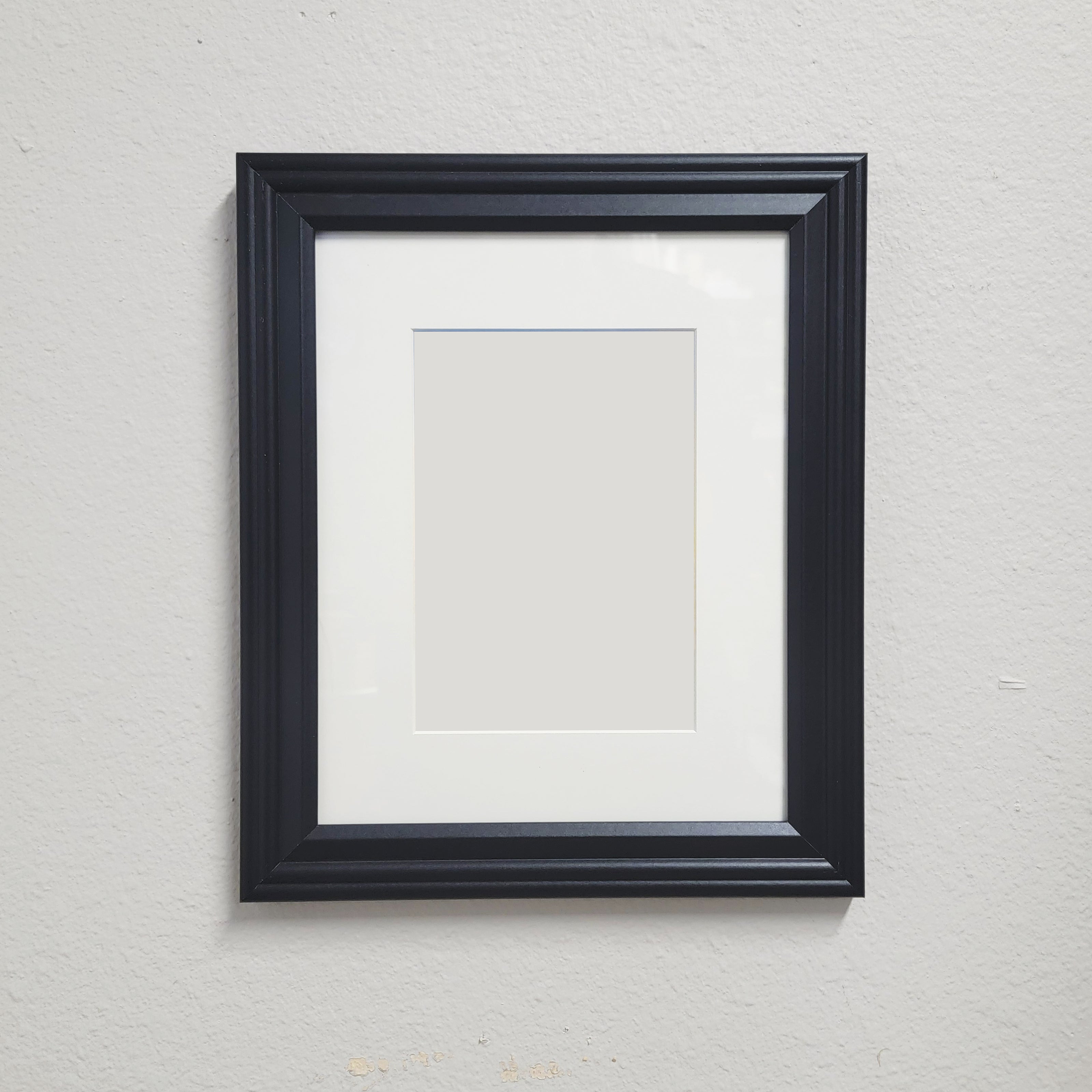 a black picture frame with a mat