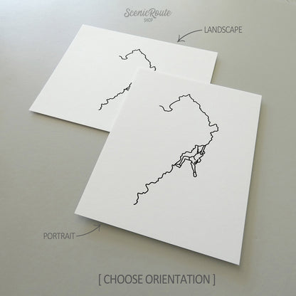 Two line art drawings of Rock Climbing on white linen paper with a gray background.  The pieces are shown in portrait and landscape orientation for the available art print options.