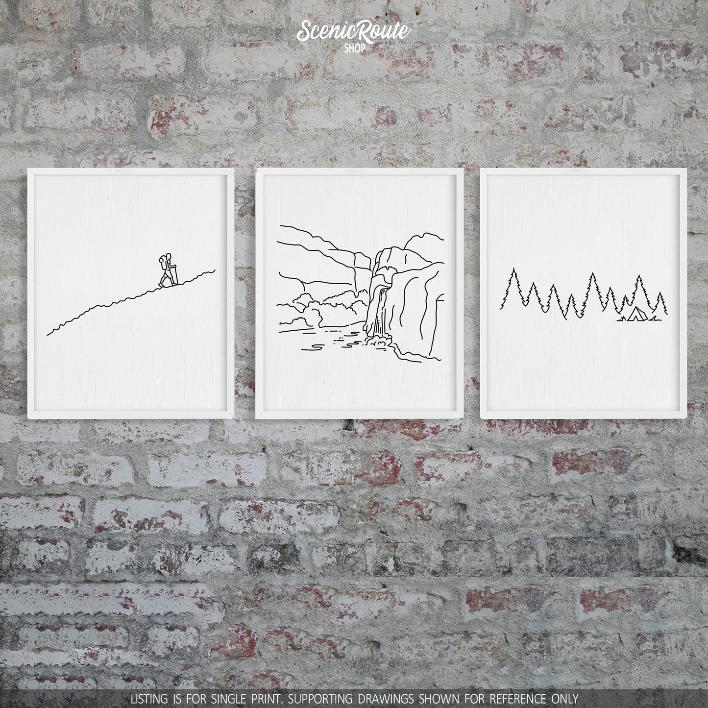 A group of three framed drawings on a brick wall. The line art drawings include a person Hiking, Havasu Falls, and Camping