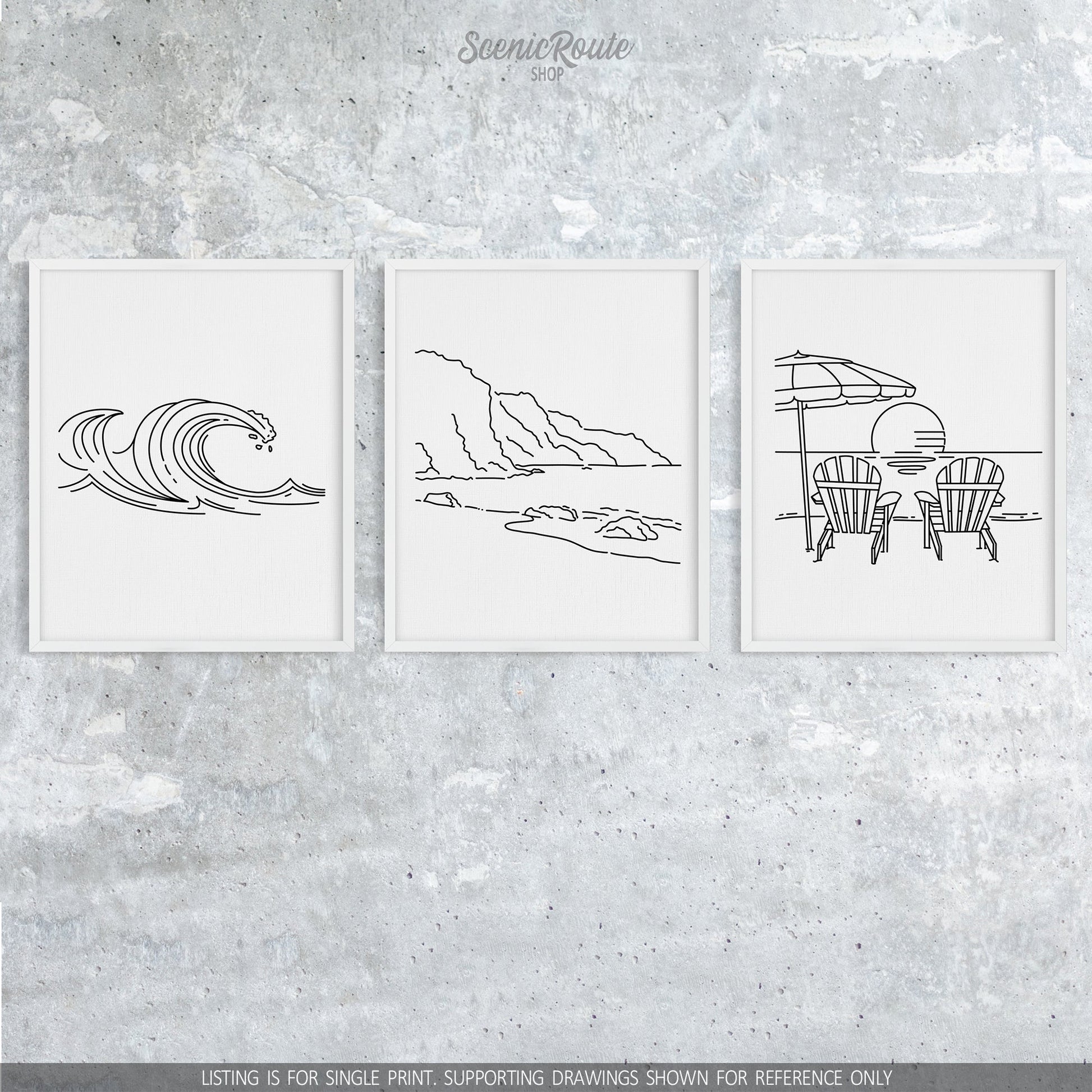 A group of three framed drawings on a concrete wall. The line art drawings include  Waves, the NaPali Coast, and Adirondack Beach Chairs