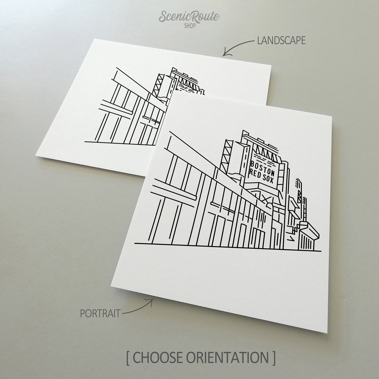 Two line art drawings of Fenway Park on white linen paper with a gray background.  The pieces are shown in portrait and landscape orientation for the available art print options.