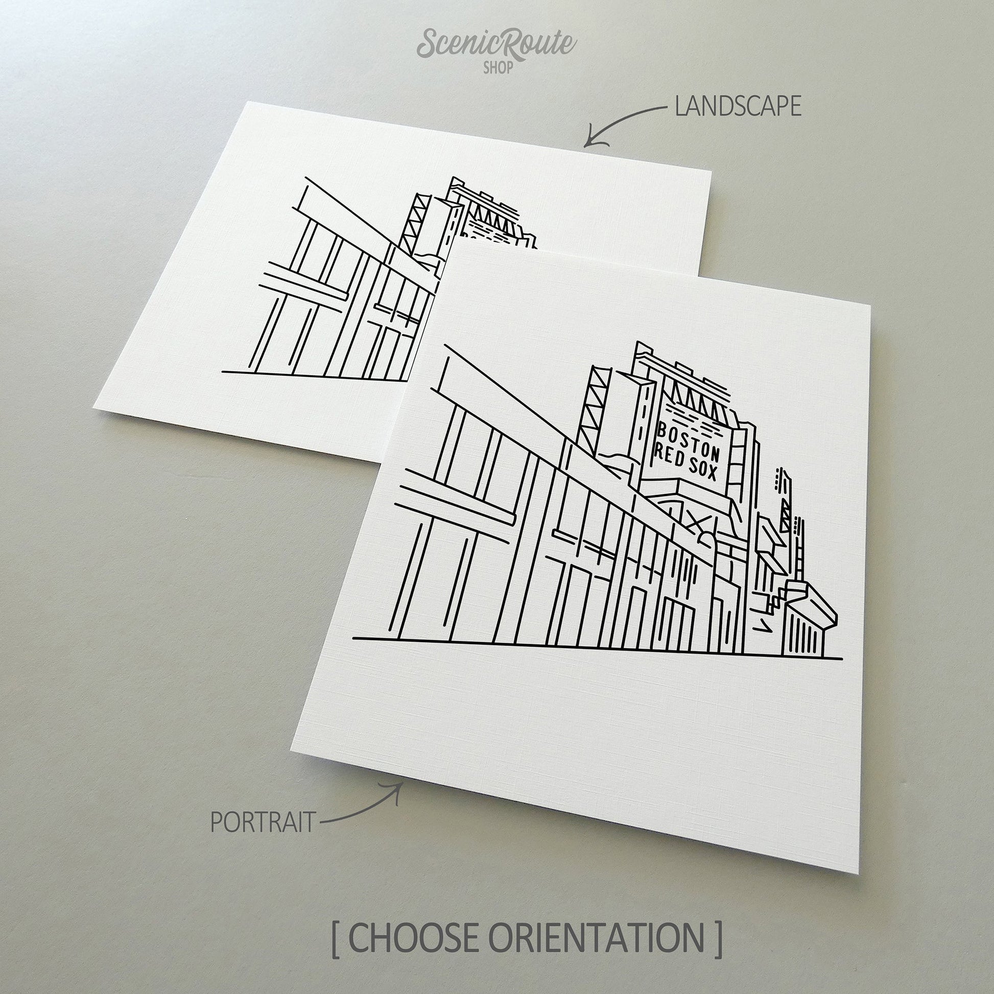 Two line art drawings of Fenway Park on white linen paper with a gray background.  The pieces are shown in portrait and landscape orientation for the available art print options.