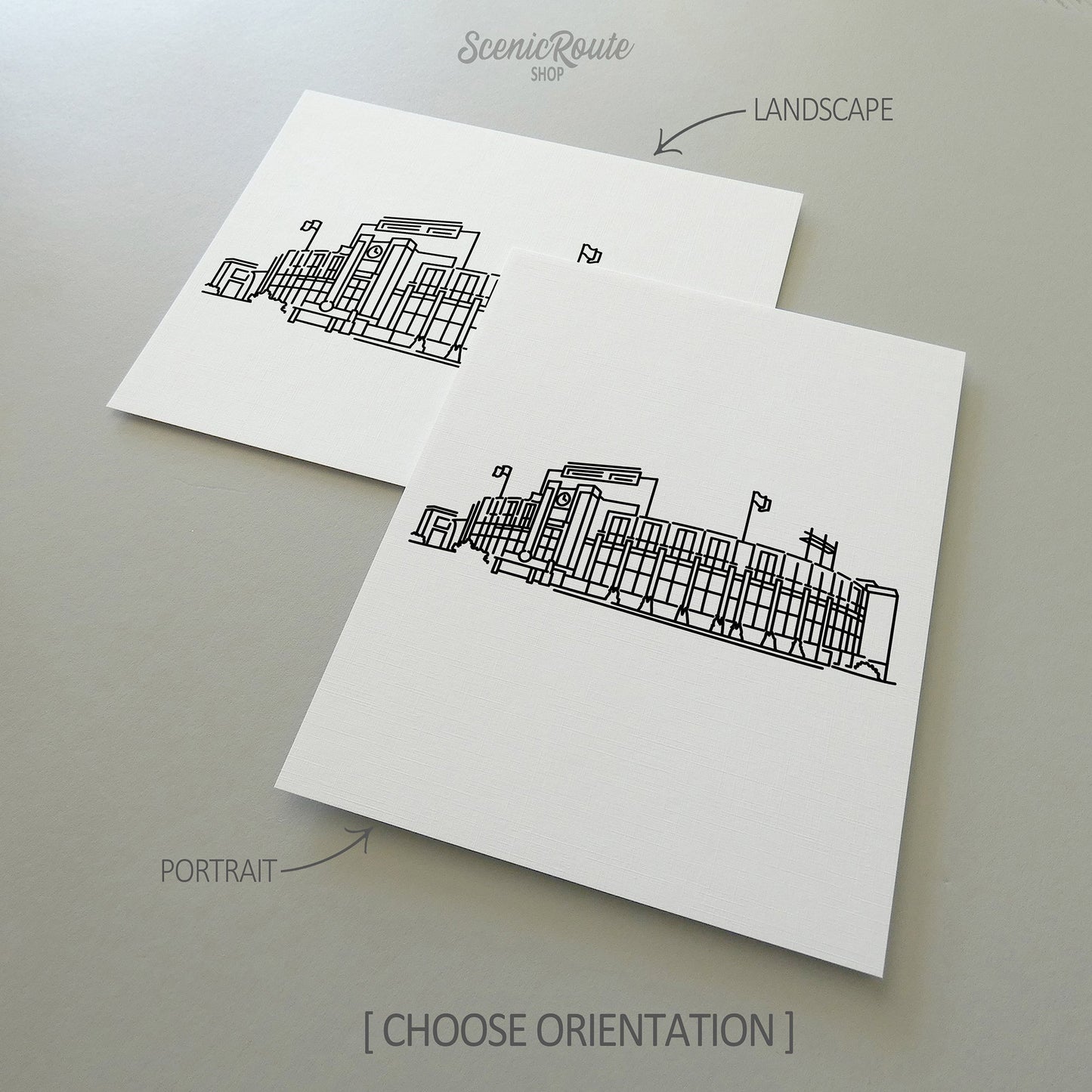 Two line art drawings of Lambeau Field on white linen paper with a gray background.  The pieces are shown in portrait and landscape orientation for the available art print options.