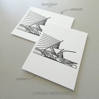Two line art drawings of the Milwaukee Art Museum on white linen paper with a gray background.  The pieces are shown in portrait and landscape orientation for the available art print options.