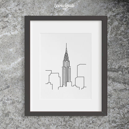 A framed line art drawing of the Chrysler Building
