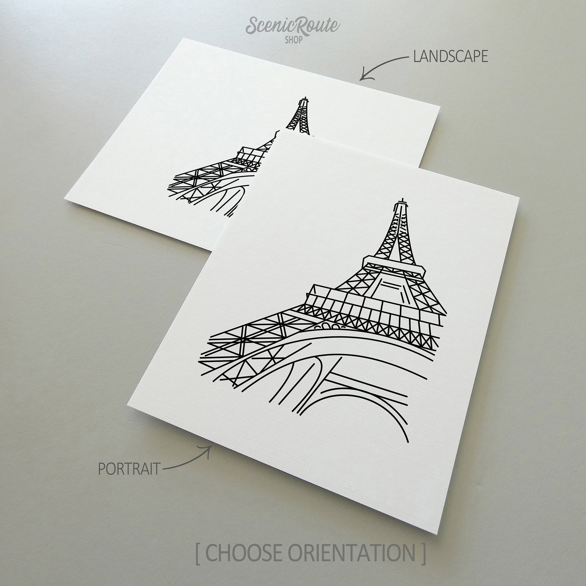 Two line art drawings of the Eiffel Tower on white linen paper with a gray background.  The pieces are shown in portrait and landscape orientation for the available art print options.