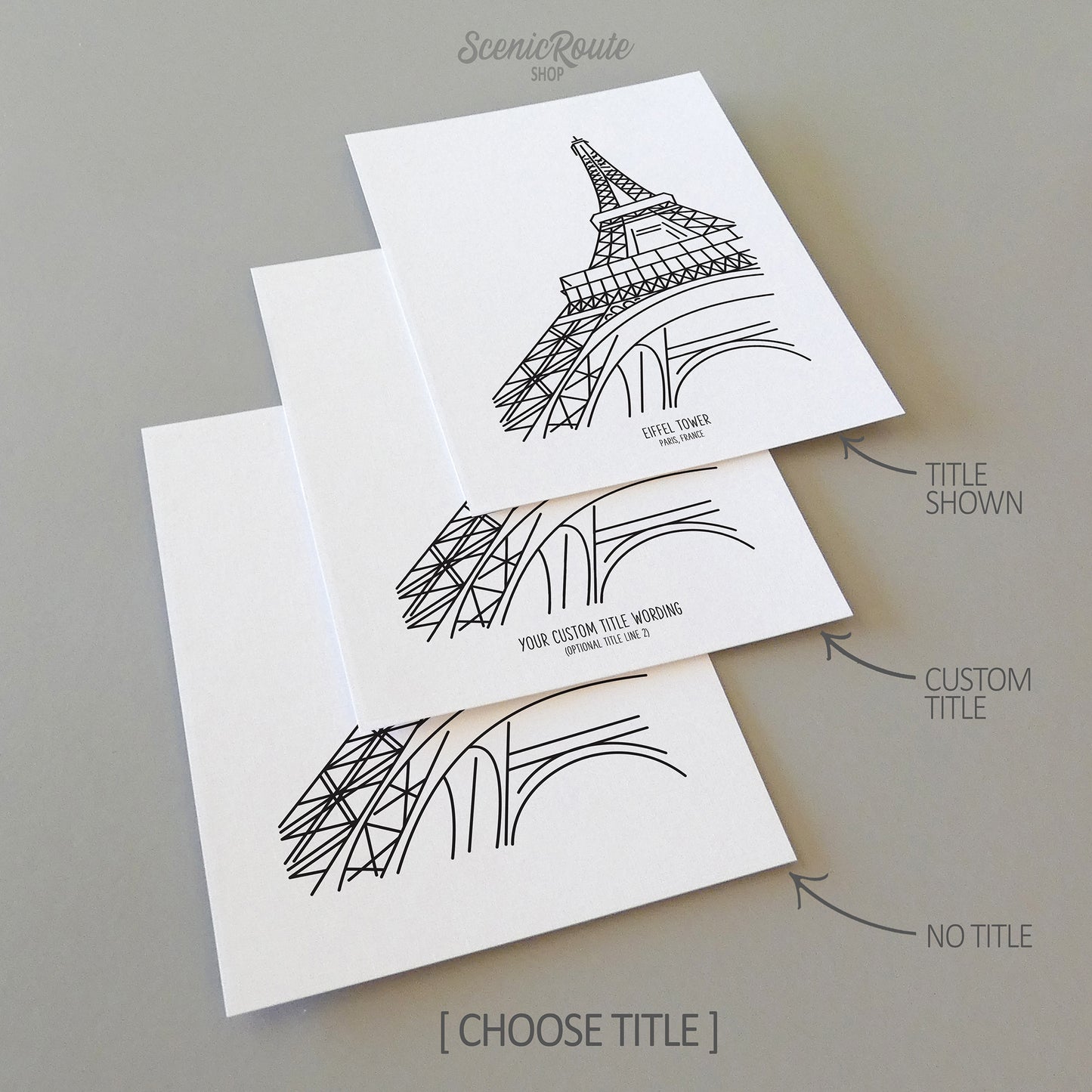 Three line art drawings of the Eiffel Tower in Paris France on white linen paper with a gray background.  The pieces are shown with title options that can be chosen and personalized.