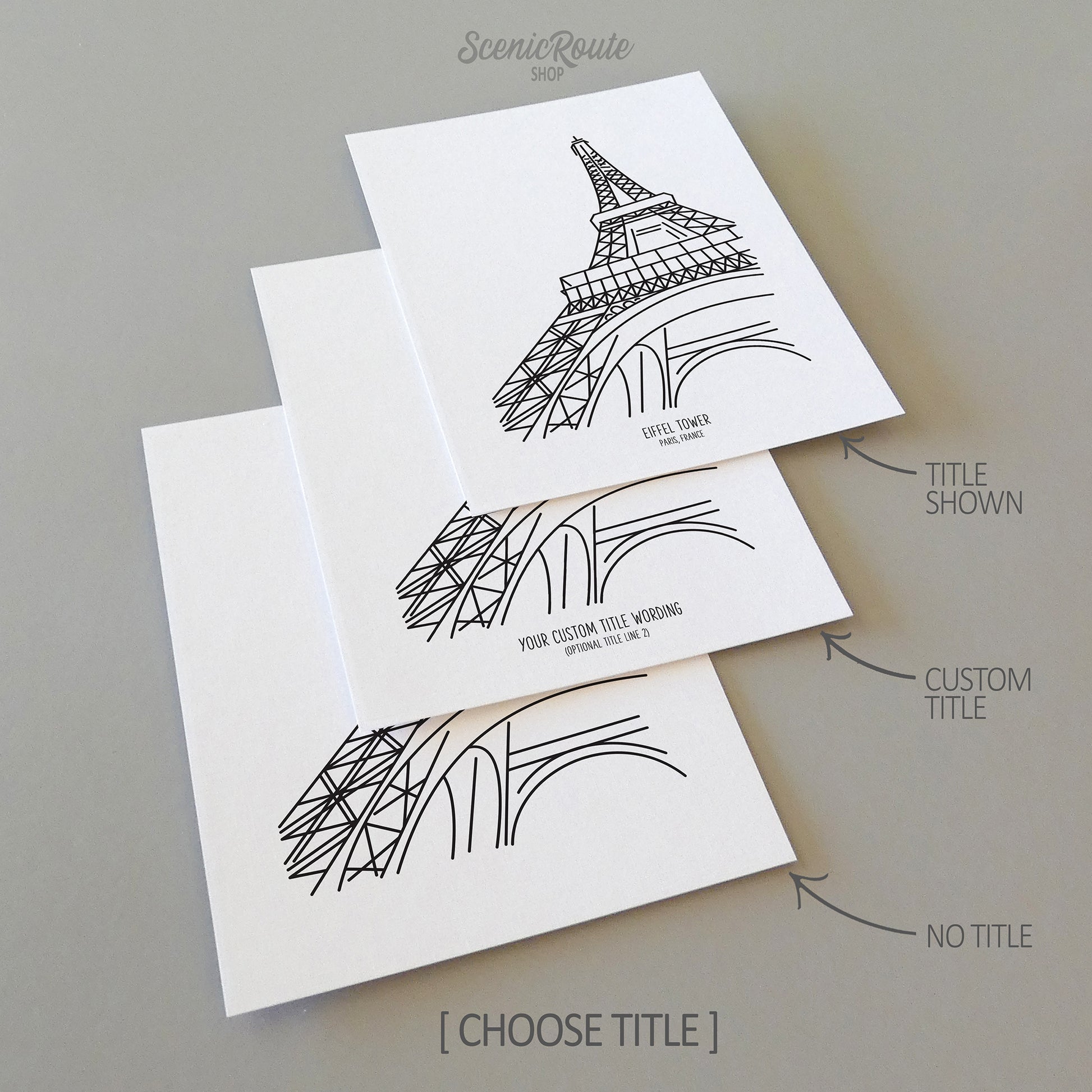 Three line art drawings of the Eiffel Tower in Paris France on white linen paper with a gray background.  The pieces are shown with title options that can be chosen and personalized.
