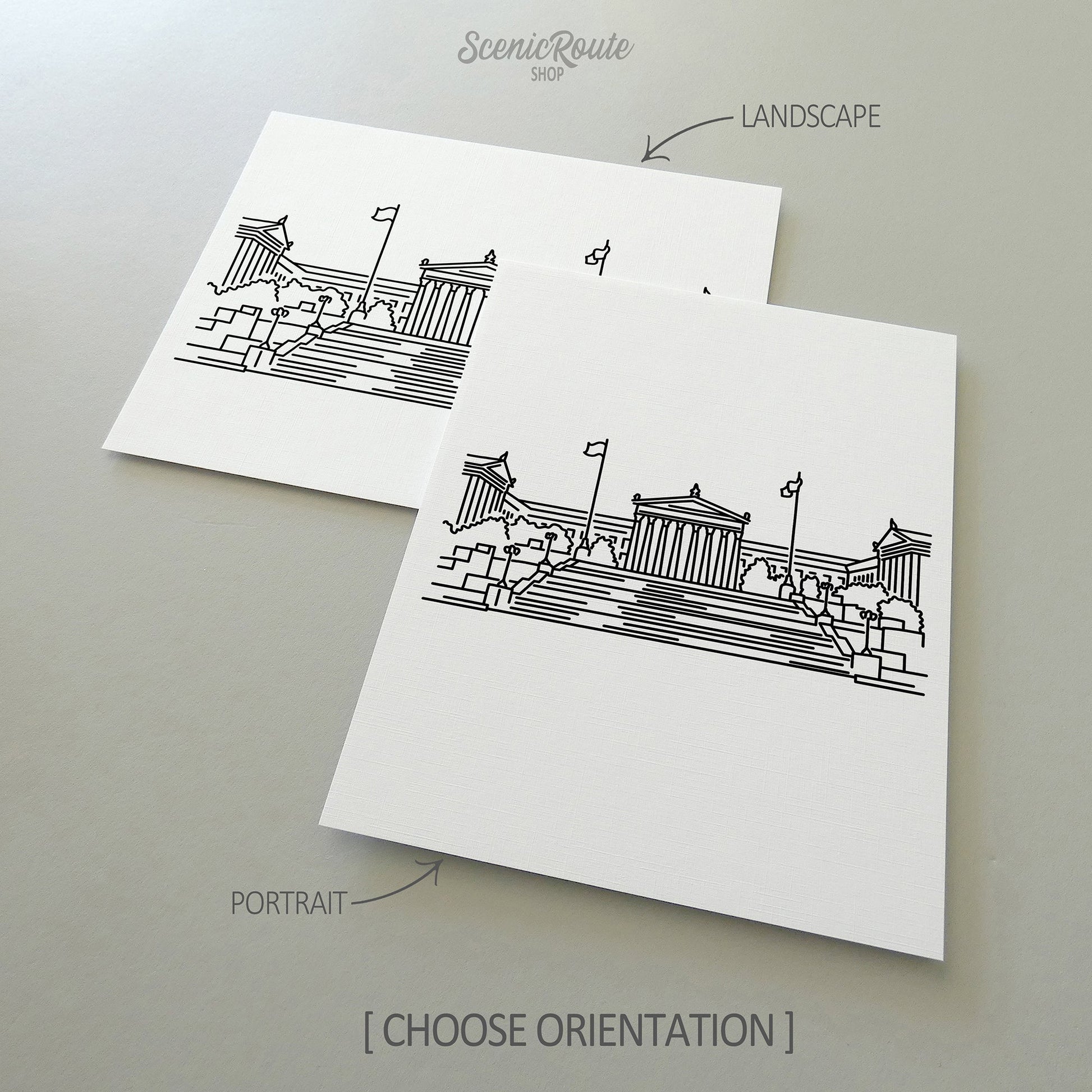 Two line art drawings of the Philadelphia Art Museum on white linen paper with a gray background.  The pieces are shown in portrait and landscape orientation for the available art print options.