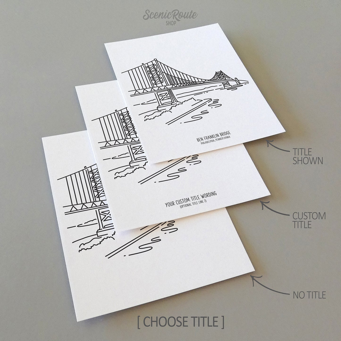 Three line art drawings of the Ben Franklin Bridge in Philadelphia Pennsylvania on white linen paper with a gray background.  The pieces are shown with title options that can be chosen and personalized.
