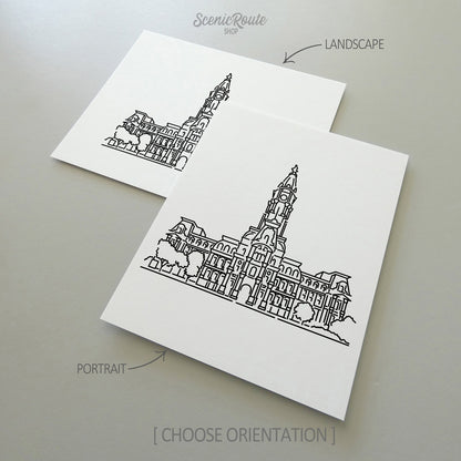 Two line art drawings of Philadelphia City Hall on white linen paper with a gray background.  The pieces are shown in portrait and landscape orientation for the available art print options.