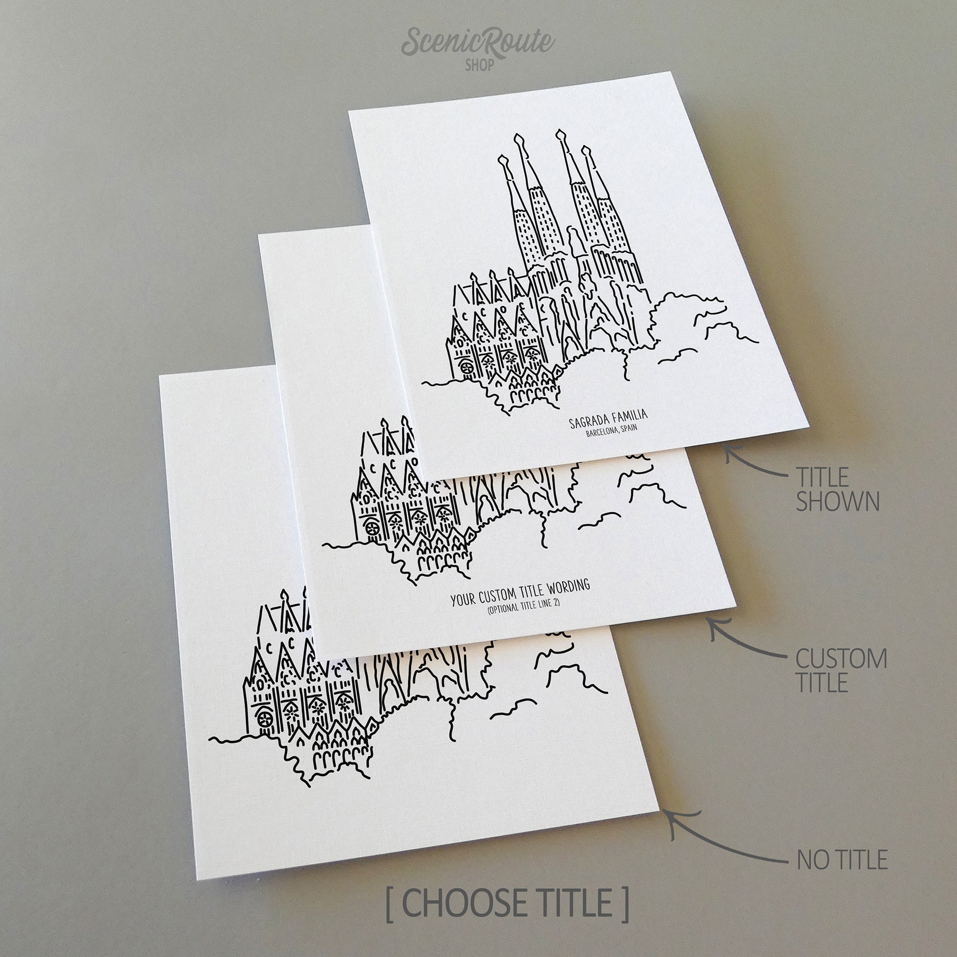 Three line art drawings of the Sagrada Familia on white linen paper with a gray background. The pieces are shown with title options that can be chosen and personalized.