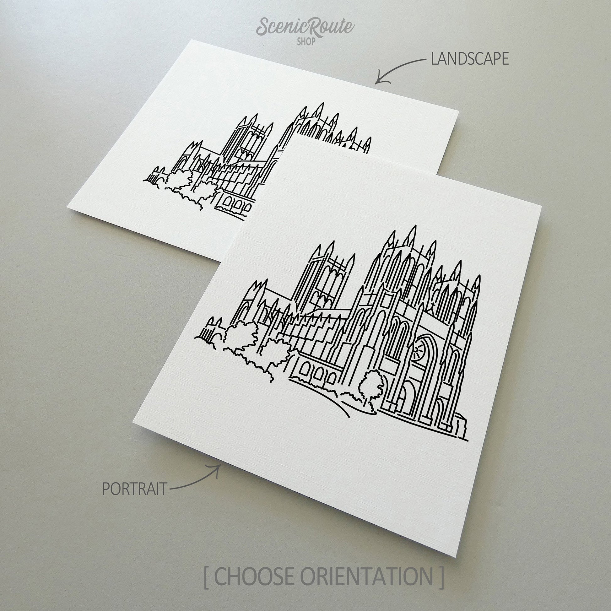 Two line art drawings of the National Cathedral on white linen paper with a gray background.  The pieces are shown in portrait and landscape orientation for the available art print options.