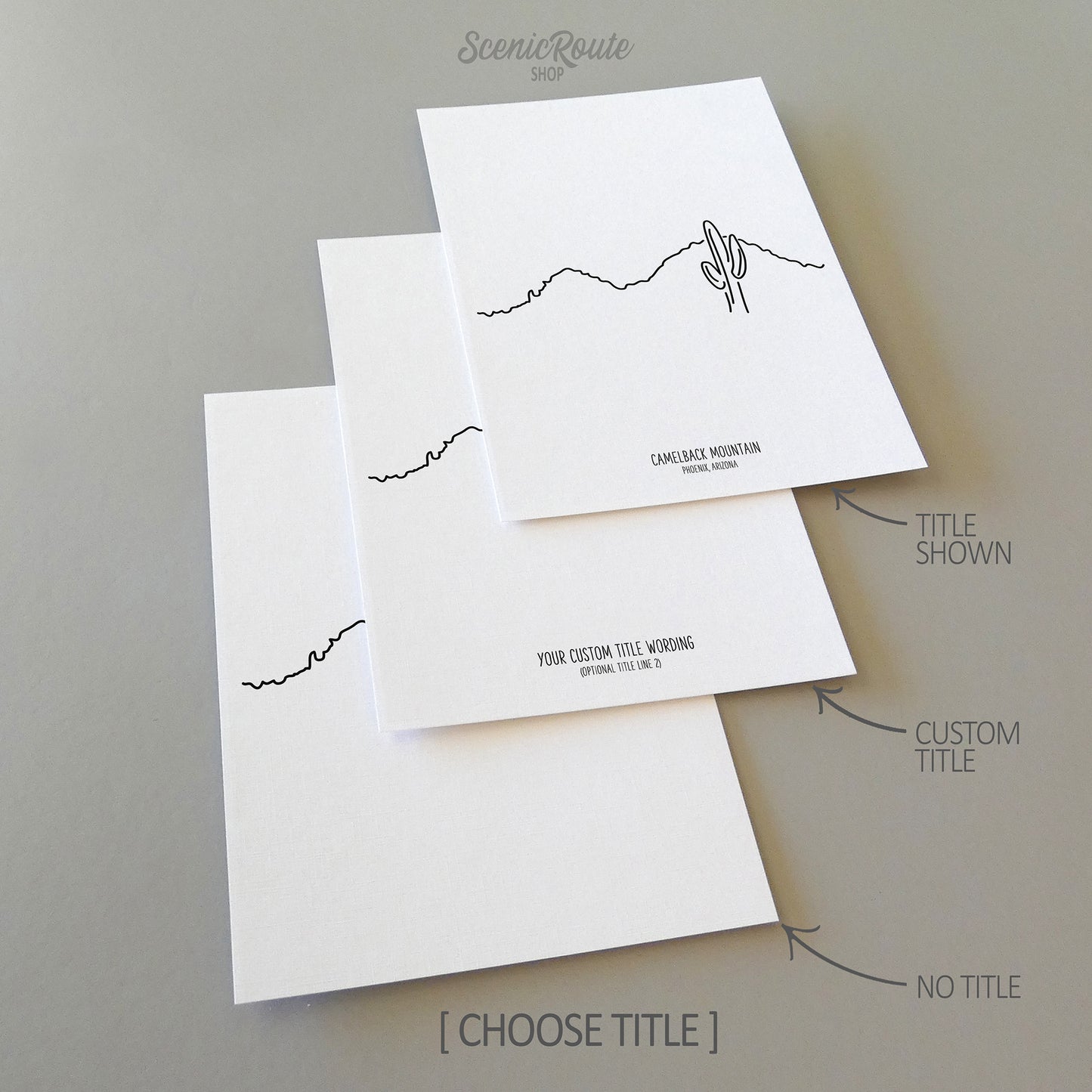 Three line art drawings of Camelback Mountain on white linen paper with a gray background.  The pieces are shown with title options that can be chosen and personalized.