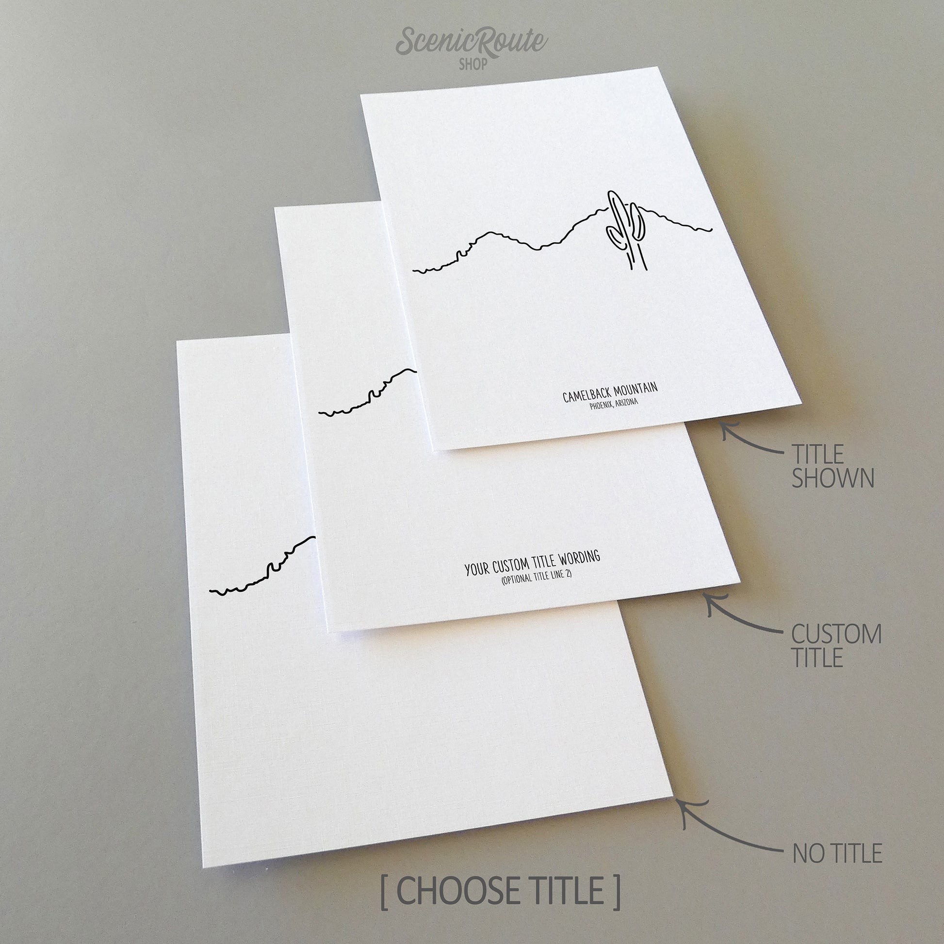 Three line art drawings of Camelback Mountain on white linen paper with a gray background.  The pieces are shown with title options that can be chosen and personalized.