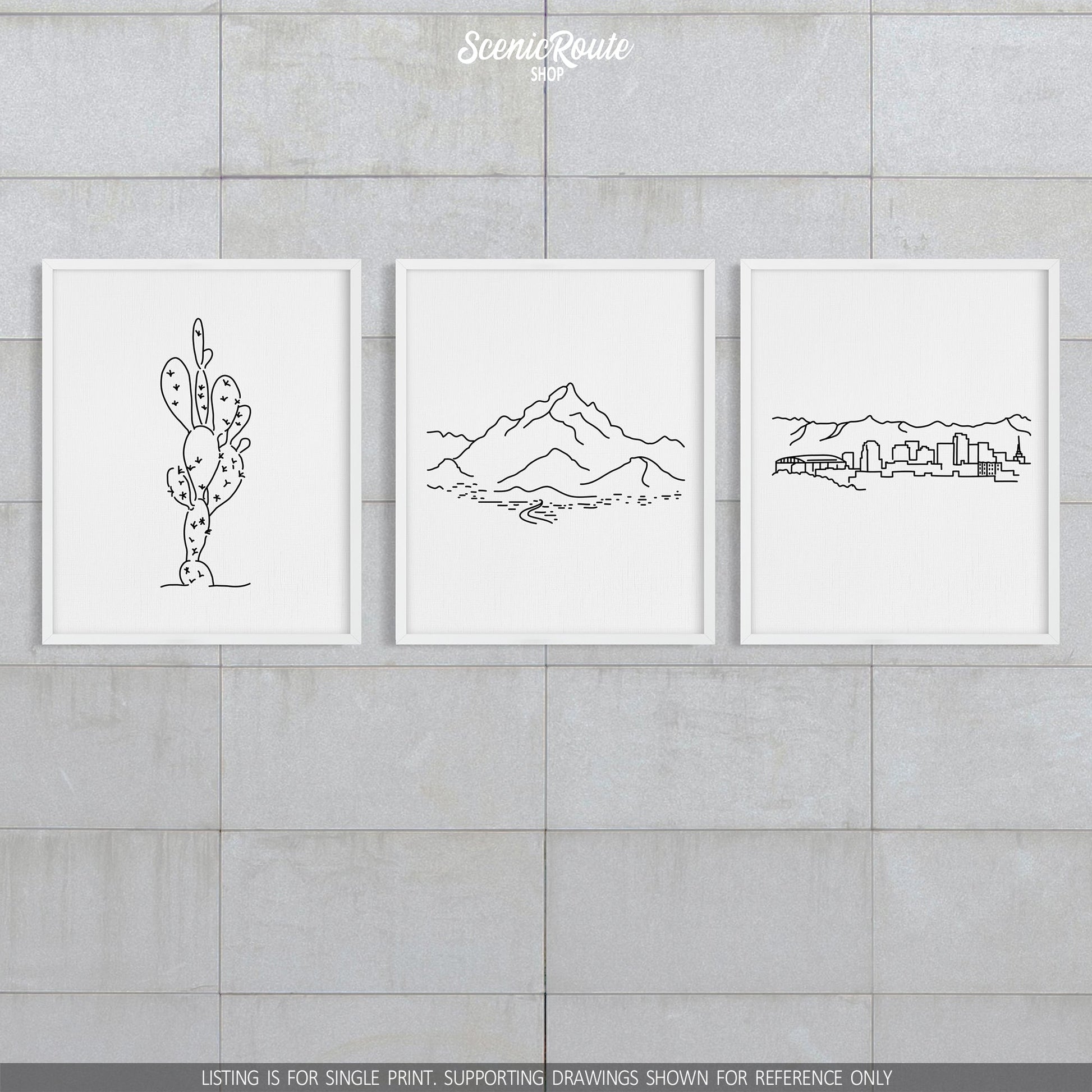 A group of three framed drawings on a block wall. The line art drawings include a Prickly Pear Cactus, Piestewa Peak, and the Phoenix Skyline