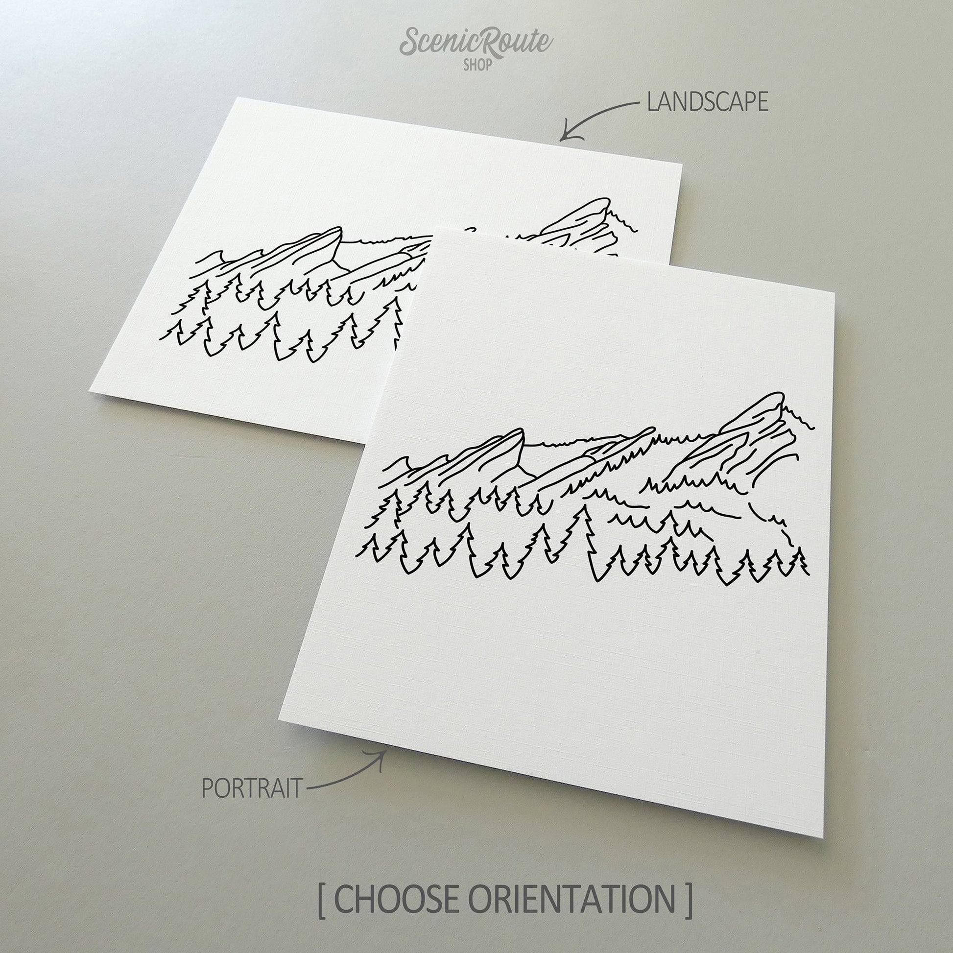 Two line art drawings of The Flatiron Mountains on white linen paper with a gray background.  The pieces are shown in portrait and landscape orientation for the available art print options.