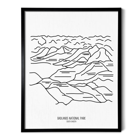 A line art drawing of Badlands National Park on white linen paper in a thin black picture frame