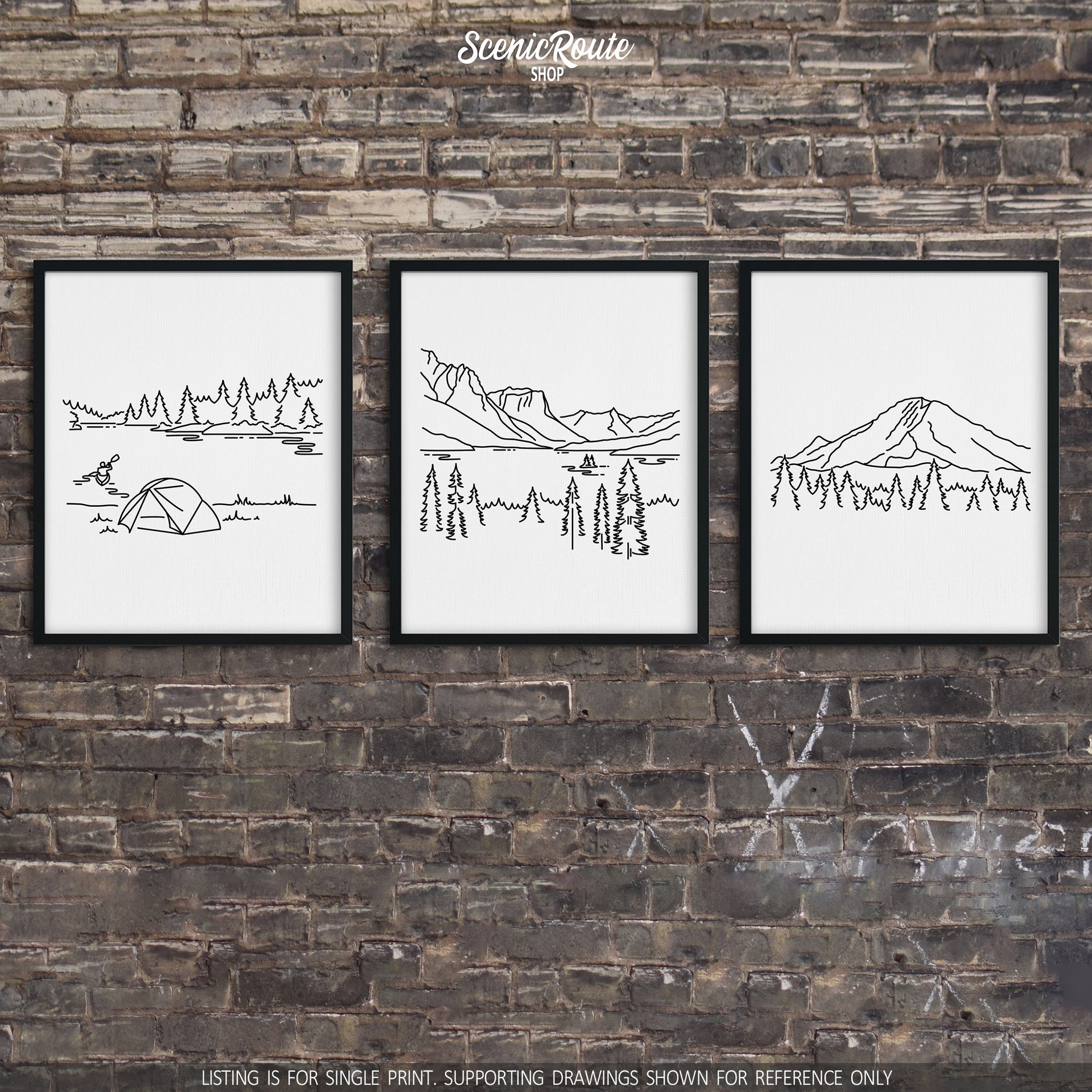 A group of three framed drawings on a brick wall. The line art drawings include Voyageurs National Park, Glacier National Park, and Mount Rainier National Park