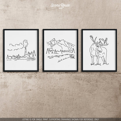 A group of three framed drawings on a concrete wall. The line art drawings include Yellowstone National Park, Grand Teton National Park, and a Moose