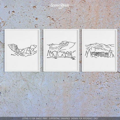 A group of three framed drawings on a concrete wall. The line art drawings include Yosemite National Park, Great Basin National Park, and Breckenridge
