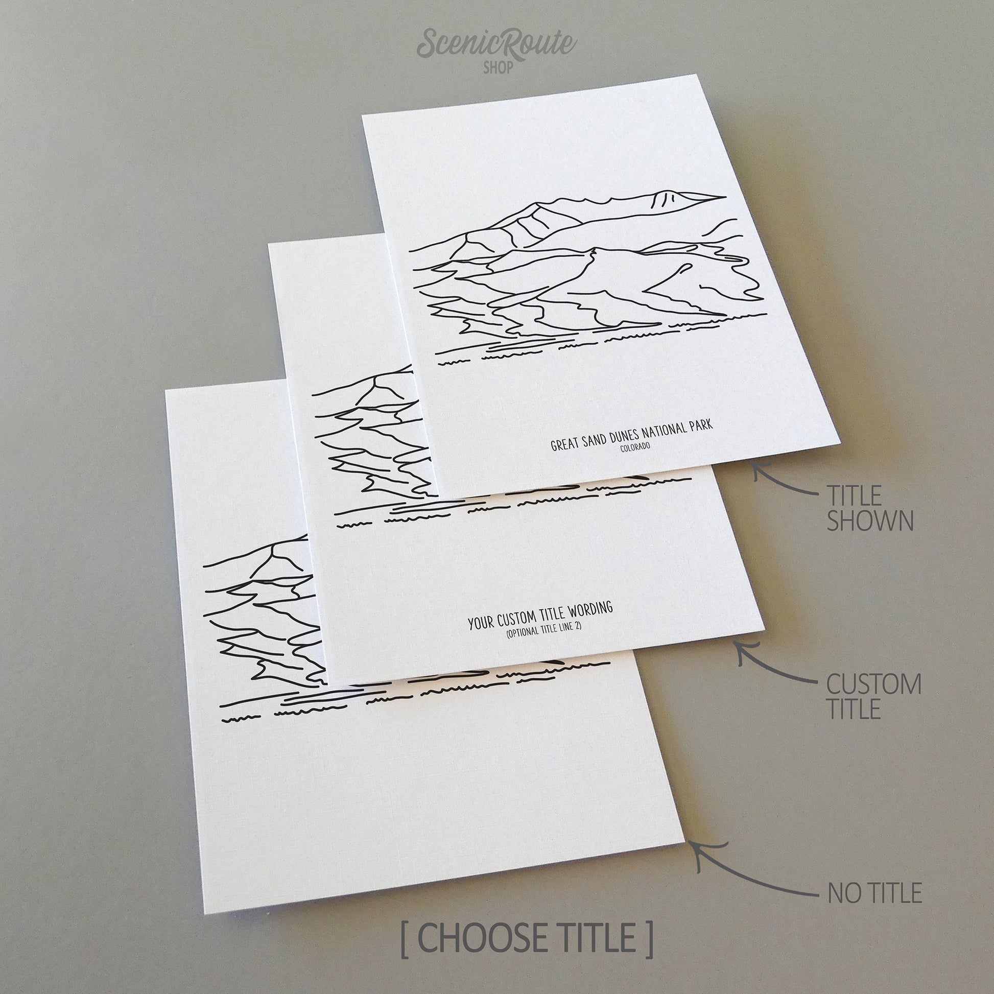 Three line art drawings of Great Sand Dunes National Park on white linen paper with a gray background. The pieces are shown with title options that can be chosen and personalized.