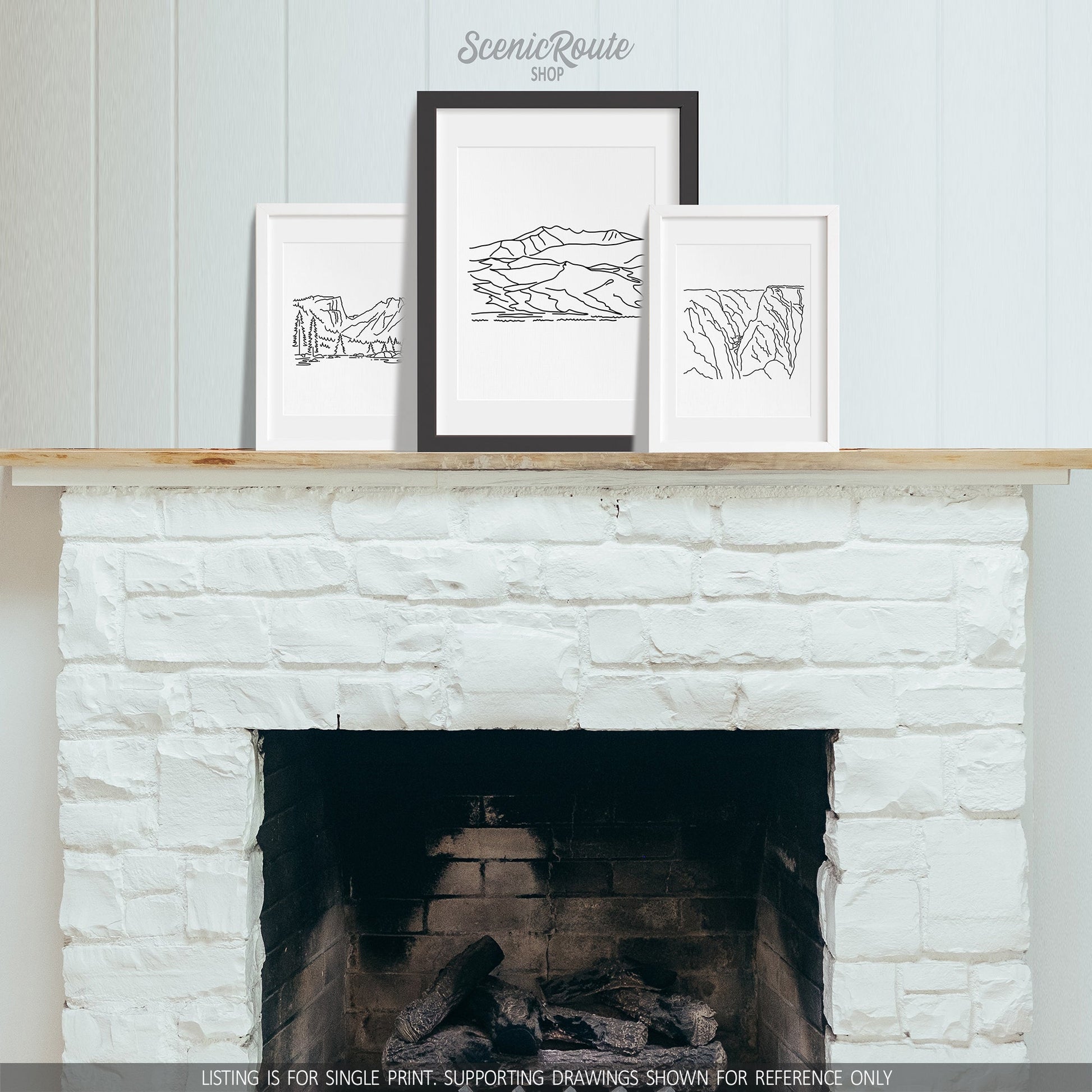 A group of three framed drawings on a fireplace mantle. The line art drawings include Rocky Mountain National Park, Great Sand Dunes National Park, and Black Canyon of the Gunnison National Park