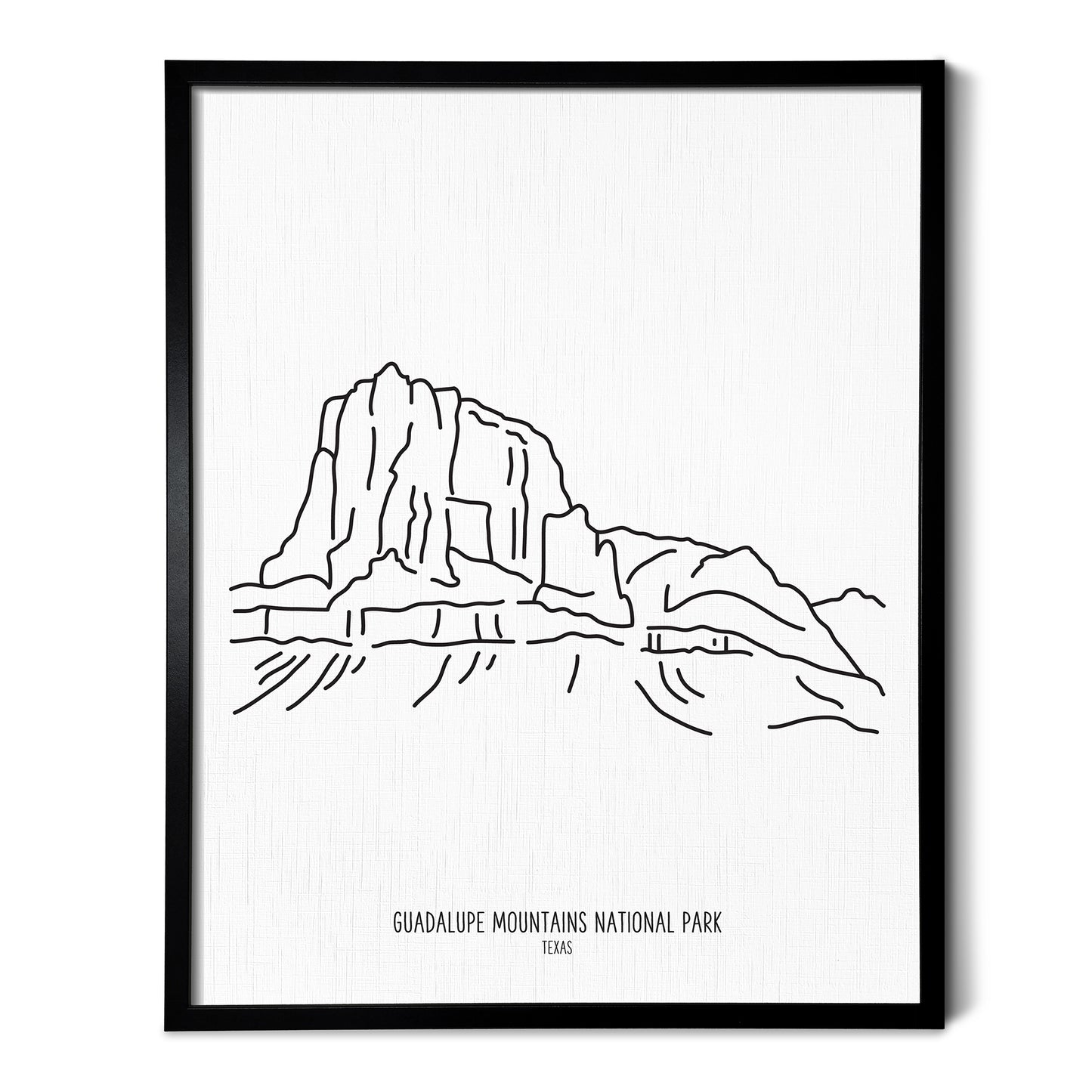 A line art drawing of Guadalupe Mountains National Park on white linen paper in a thin black picture frame